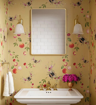 Playful yellow bee print wallpaper in a small bathroom.
