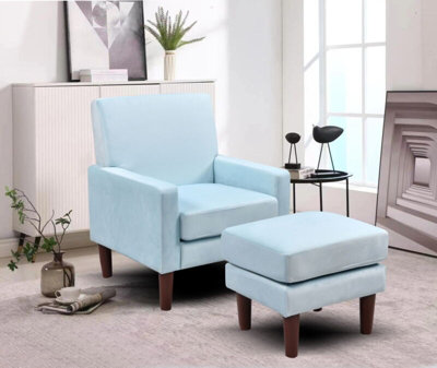 Plush velvet chair with footstool in blue
