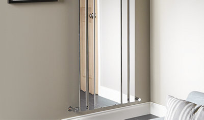 Vertical mirrored radiator with a larger flat mirrored panel in the center and two smaller mirrored panels either side.