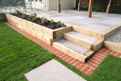 A raised patio adding depth and dimension to your garden, perfect for intimate gatherings and summer soirées.