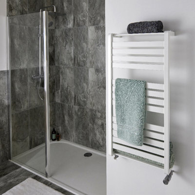 Modern walk in shower enclosure with dark grey textured tiles and a low profile shower tray.
