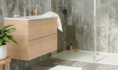 Modern bathroom space with grey textured tiles, a wood effect wall hung vanity unit and a walk in shower.
