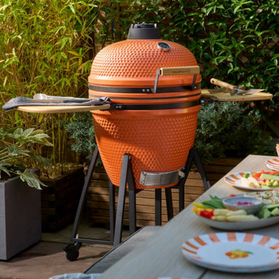 GoodHome Sagami Orange Charcoal BBQ on a modern patio