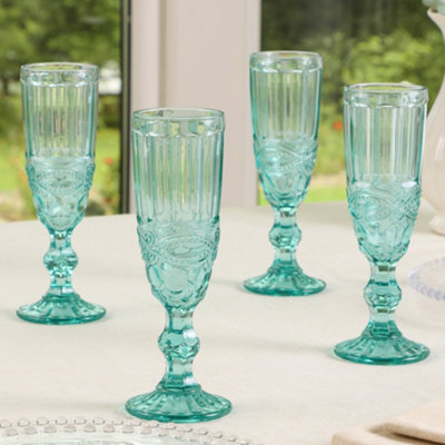 https://media.diy.com/is/image/KingfisherDigital/set-of-4-blue-turquoise-flute-champagne-glasses~5060964600505_01c_MP?$MOB_PREV$&$width=768&$height=768
