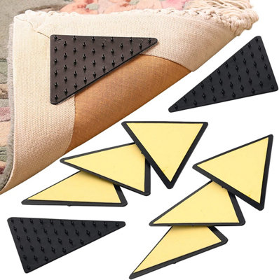 https://media.diy.com/is/image/KingfisherDigital/set-of-8-triangular-rug-grippers-anti-slip-universal-strong-gripping-spikes-for-rugs-mats-and-runners~5053335609771_01c_MP?$MOB_PREV$&$width=768&$height=768