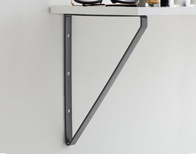 A clever triangular-shaped shelf bracket, with one part resting on the wall, another part supporting the shelf, and a cross brace between them for added stability.