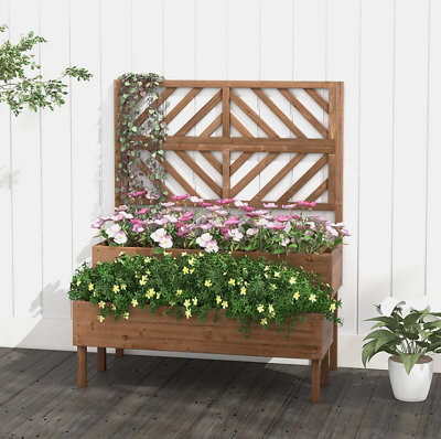 A raised wooden planter with a built-in trellis, full of blooming plants.