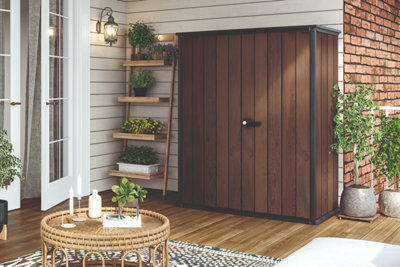 A large wooden garden store on a large balcony.