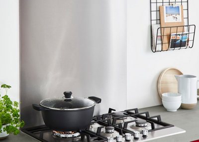 A stainless steel splashback in a kitchen.