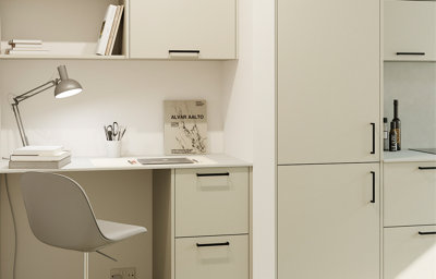 Close up of a neutral matt kitchen featuring a built-in desk space.