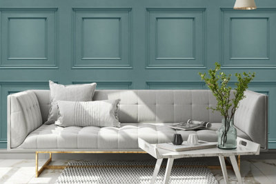 Teal panel effect shaker style wallpaper in a living room with a grey statement sofa.