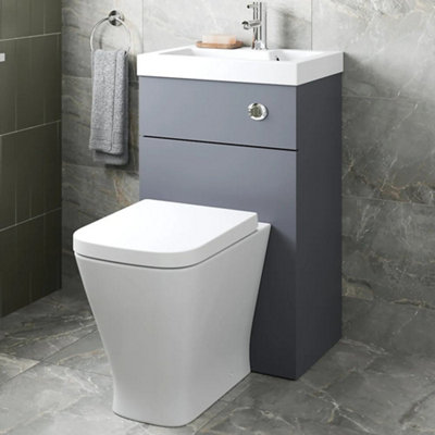 Small, grey 2 in 1 toilet and basin combi unit.