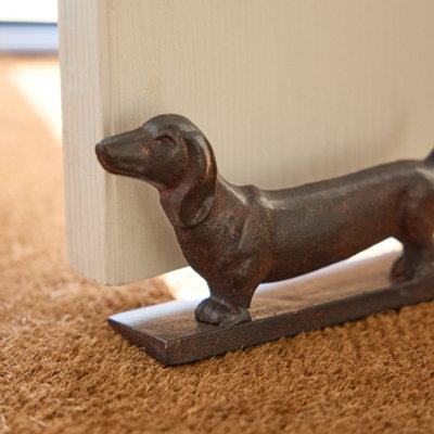 Dachshund playing with doorstop best sale