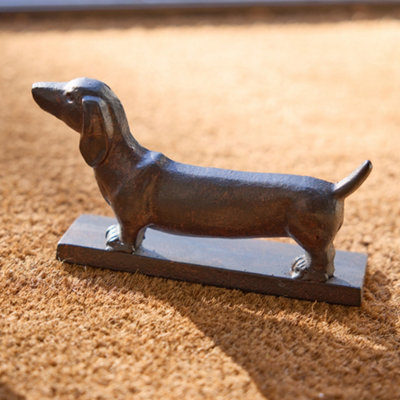 Dachshund playing with doorstop outlet
