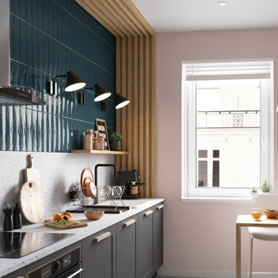 Galley kitchen with three arched wall lights placed above the splashback