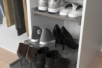 A shoe rack with pull-out drawers and neatly stacked shoes on top.