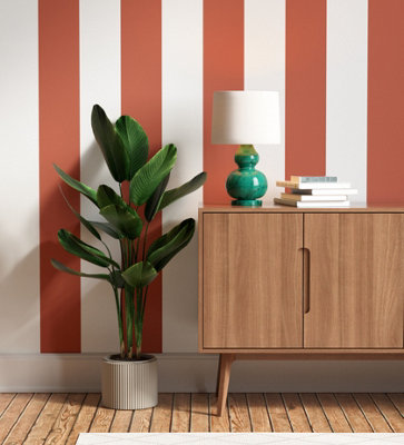 White and dark orange striped wallpaper in a living room.