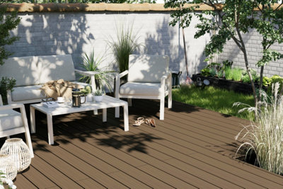 Outdoor space with whitewashed walls, brown decking and matching white furniture, creating a bright, open feel.