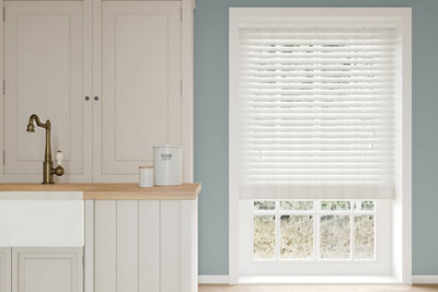 Large window covered with blinds.