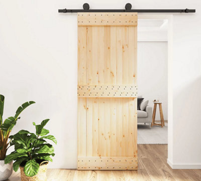 A wooden sliding door on a black rail.